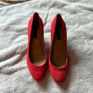 Red suede pumps
